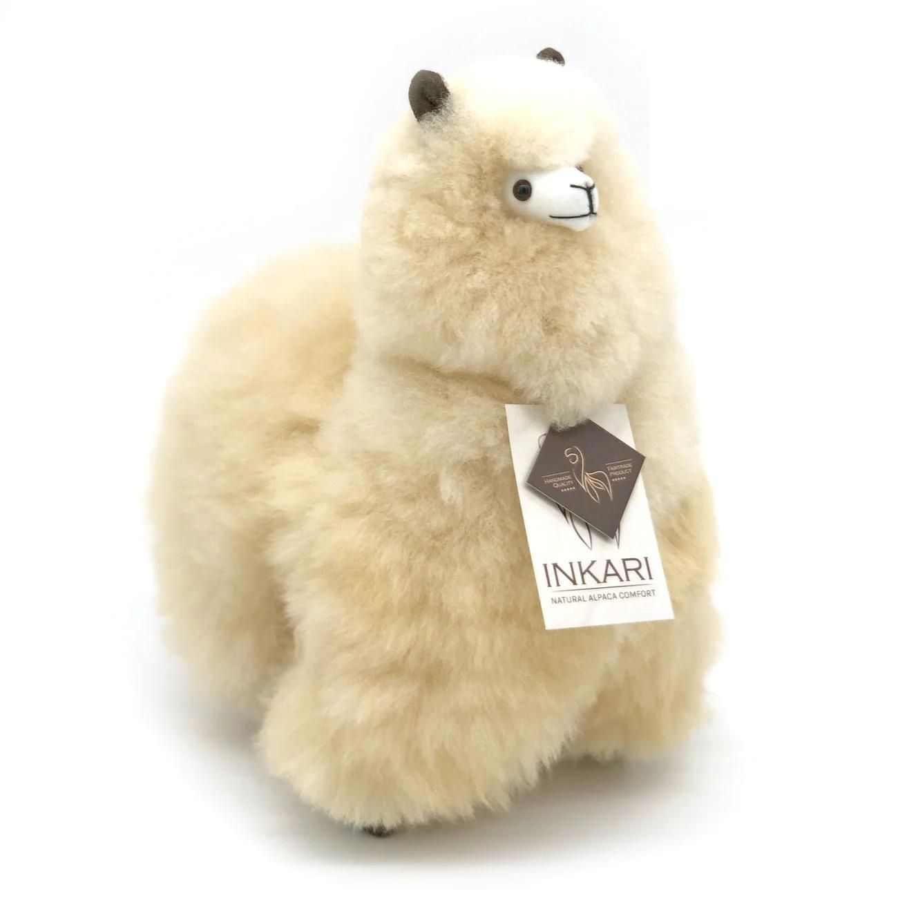 a teddy bear with a name tag sitting on it 