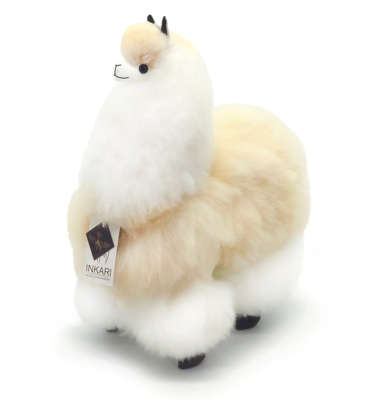 a white stuffed animal sitting on a white surface 