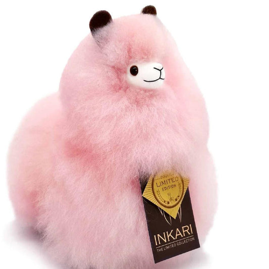 a pink teddy bear with a sticker on it 