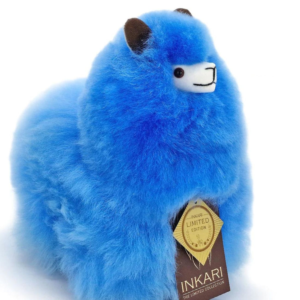 a blue teddy bear sitting on a bench 