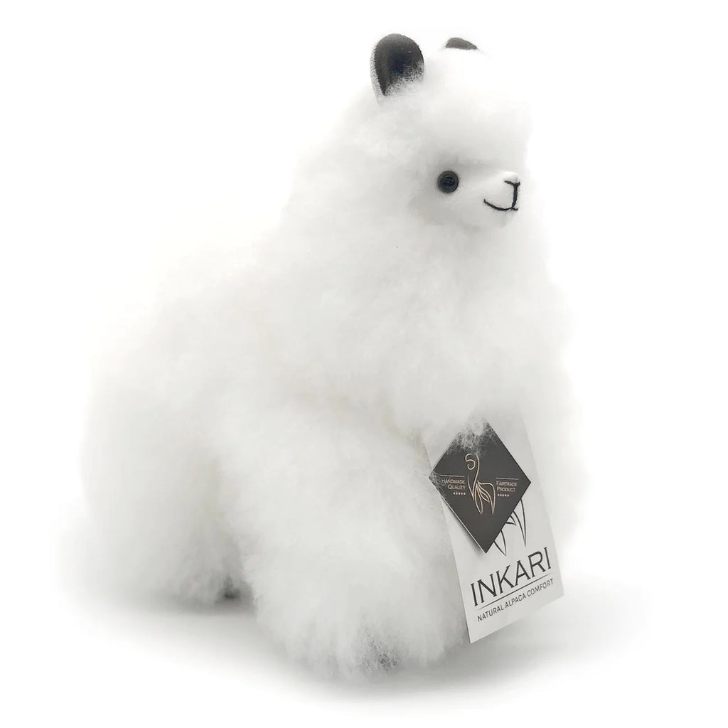 a white stuffed animal is sitting on a bench 