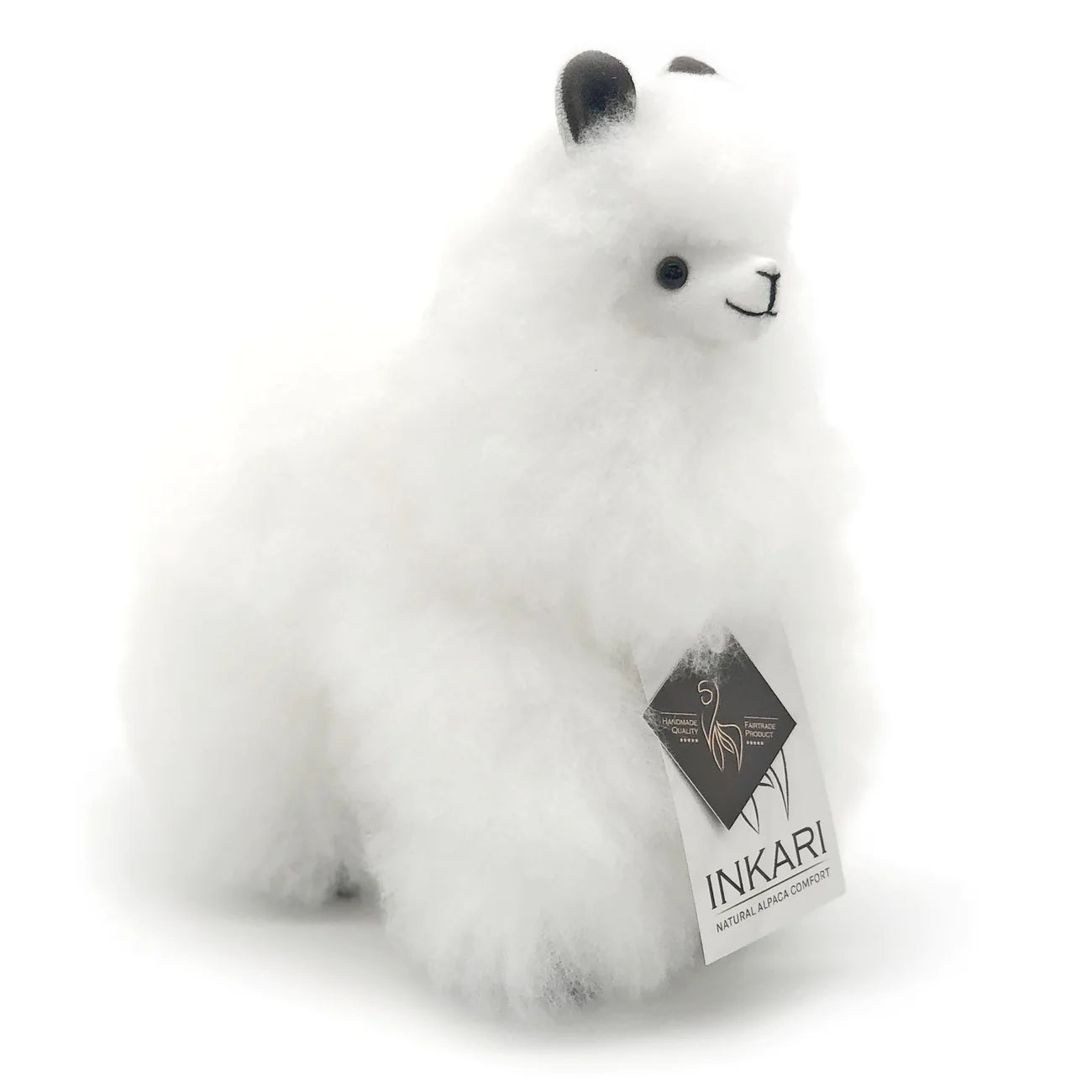 a white stuffed animal is sitting on a bench 