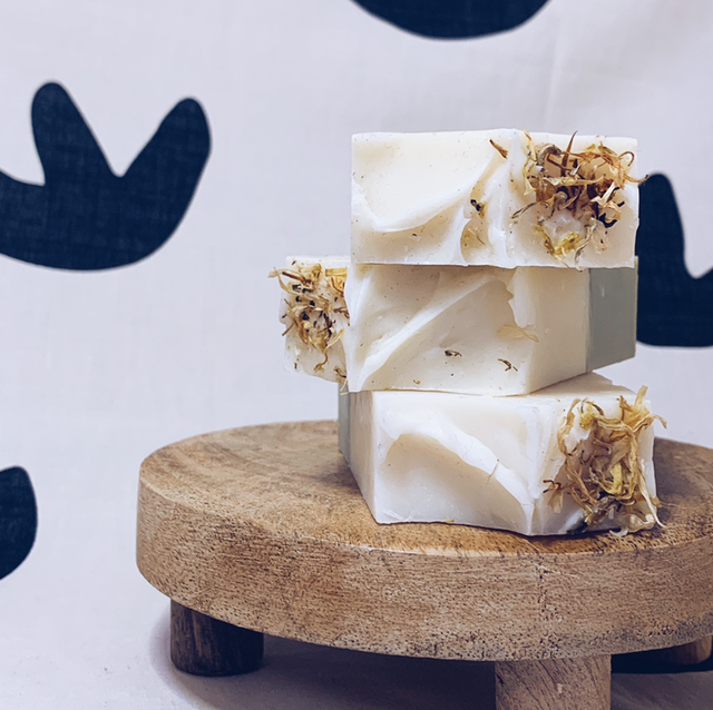 a white cake with white frosting and flowers 