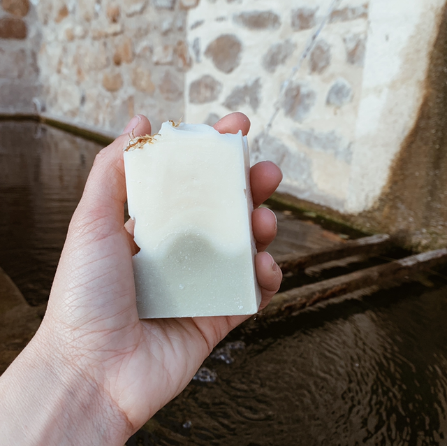 a close up of a person holding a piece of food 