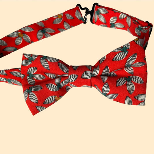 a close up of a person wearing a red bow tie 